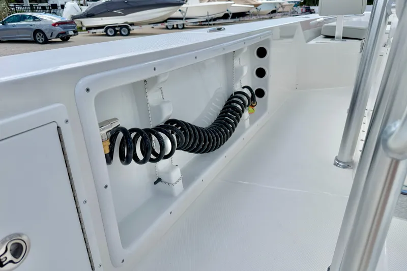 Slide: The Image of 2027 Bay Rider 2260 FS Skiff interior with coiled hose and storage compartment. - 42