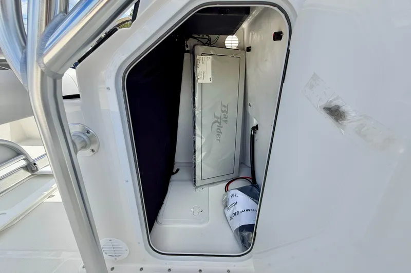 Slide: The Image of Storage compartment of 2027 Bay Rider 2260 FS Skiff, featuring interior equipment and wiring. - 46