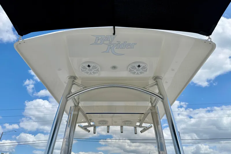 Slide: The Image of Bay Rider 2260 FS Skiff 2027 boat canopy with speakers against blue sky. - 47
