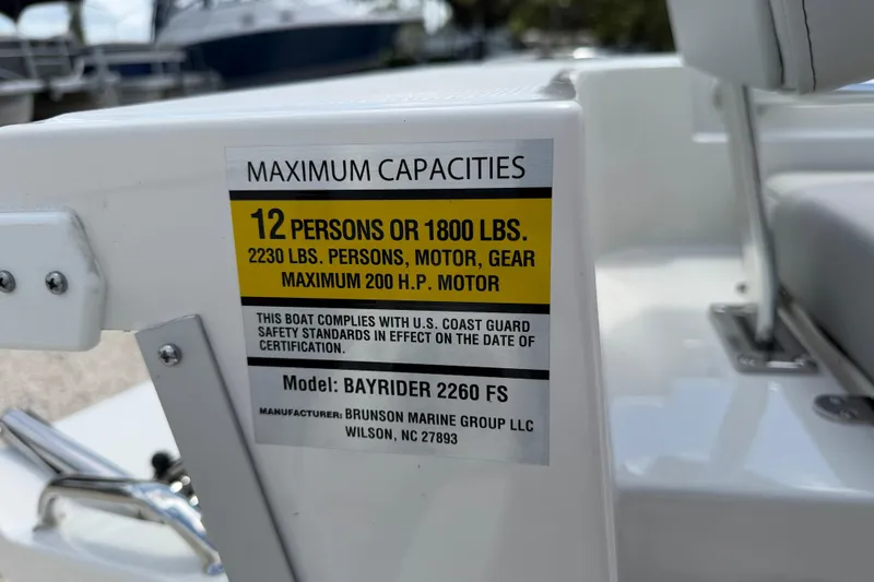 Slide: The Image of Bay Rider 2260 FS Skiff 2027 capacity label, 12 persons or 1800 lbs, 200 HP motor. - 49