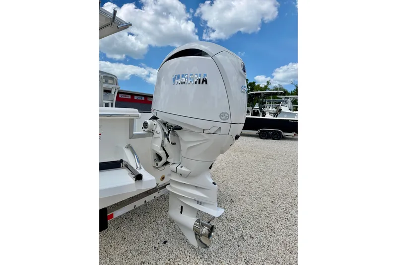 Slide: The Image of 2027 Bay Rider 2260 FS Skiff with Yamaha outboard motor, parked on gravel. - 50
