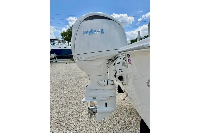 Slide: The Image of 2027 Bay Rider 2260 FS Skiff with Yamaha outboard motor in a gravel lot. - 52