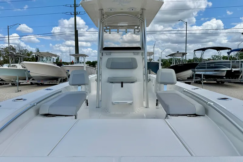 Slide: The Image of 2027 Bay Rider 2260 FS Skiff boat interior with seating, under a blue sky. - 8