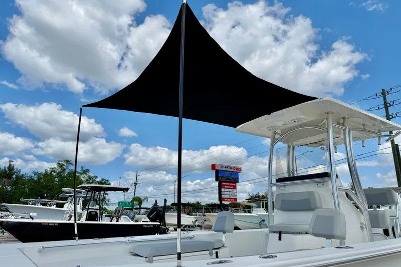 Slide: The Image of Bay Rider 2260 FS Skiff 2027 with canopy under blue sky and clouds. - 9