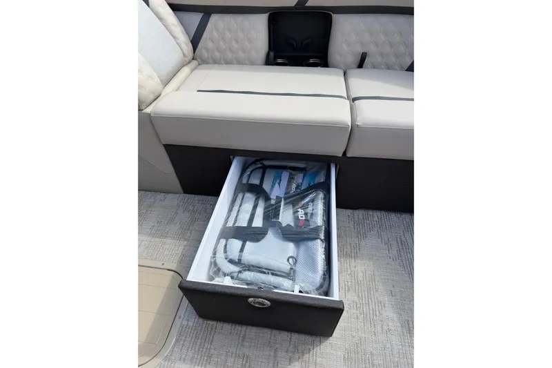 Slide: The Image of 2026 Crest Conquest 230 SLSC boat seat with under-seat storage drawer open. - 21