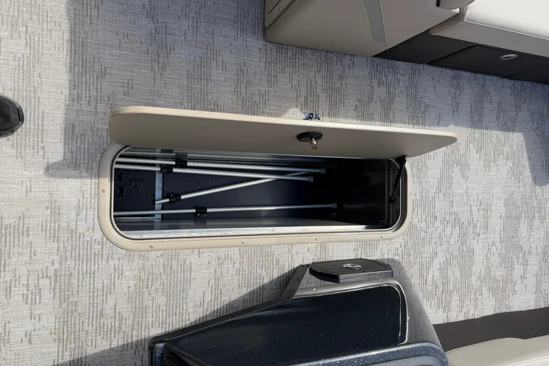 Slide: The Image of Open storage compartment on 2026 Crest Conquest 230 SLSC boat, showcasing interior space. - 23