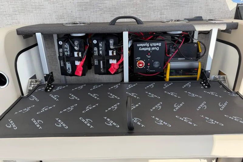 Slide: The Image of 2026 Crest Conquest 230 SLSC boat battery compartment with dual battery switch system. - 25