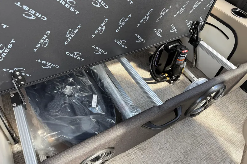 Slide: The Image of Interior view of 2026 Crest Conquest 230 SLSC boat storage compartment with equipment. - 27