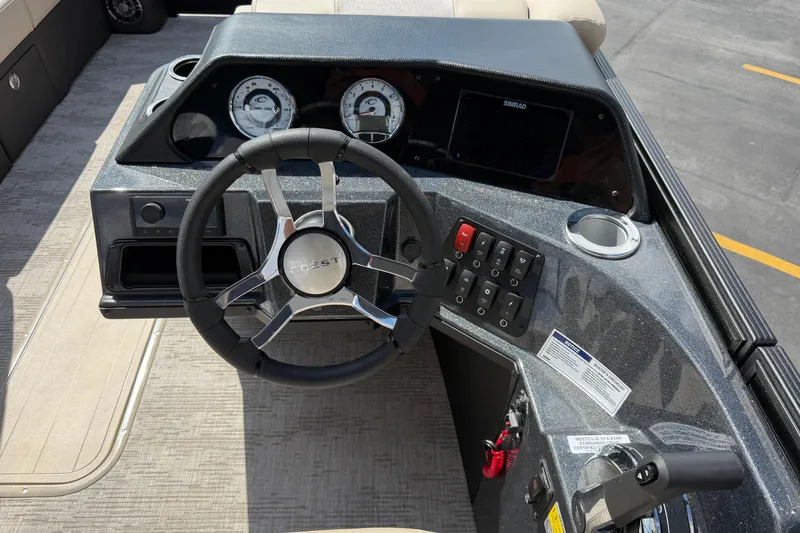 Slide: The Image of Steering console of 2026 Crest Conquest 230 SLSC boat with modern controls and gauges. - 28
