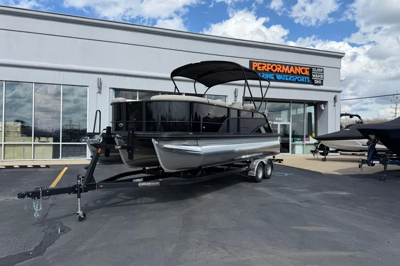 Slide: The Image of 2026 Crest Conquest 230 SLSC pontoon boat on trailer outside dealership. - 29