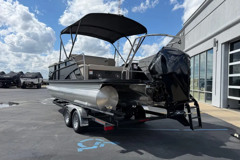 Slide: The Image of 2026 Crest Conquest 230 SLSC pontoon boat on trailer, parked outdoors under a cloudy sky. - 3