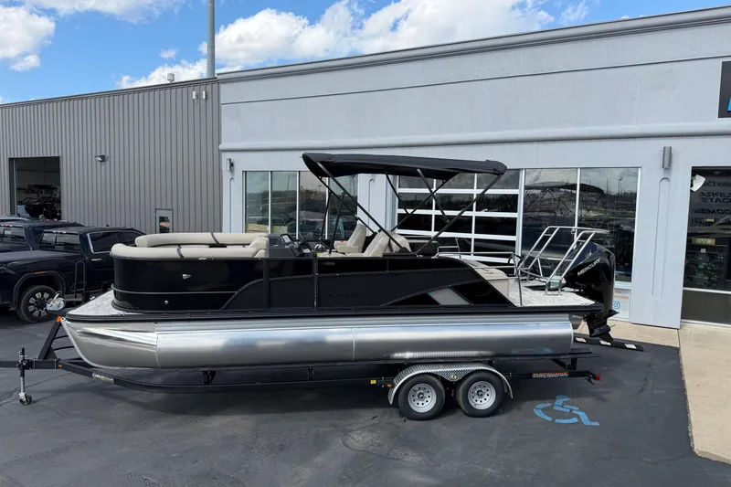 Slide: The Image of 2026 Crest Conquest 230 SLSC pontoon boat on trailer outside dealership. - 30