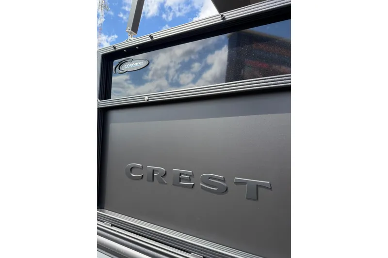 Slide: The Image of 2026 Crest Conquest 230 SLSC boat exterior with logo, under blue sky. - 4