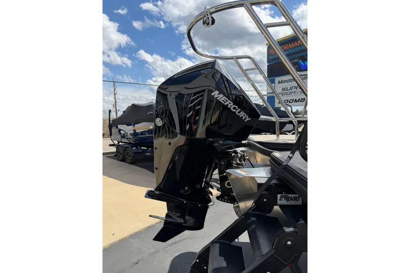 Slide: The Image of 2026 Crest Conquest 230 SLSC with Mercury outboard motor, outdoor display. - 7