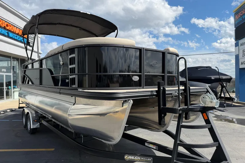 Slide: The Image of 2026 Crest Conquest 230 SLSC pontoon boat on trailer, displayed outdoors. - 9