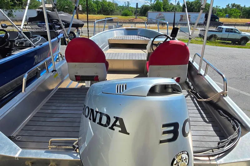 Slide: The Image of 2023 Marlon MV 16 boat with Honda 30 engine, featuring red seats and sleek design. - 6