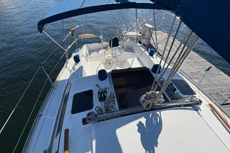 Slide: The Image of Sailboat Hunter 28, 1993 model, docked with blue canopy and visible deck details. - 15