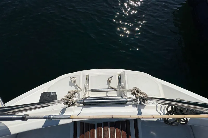 Slide: The Image of Bow view of a 1993 Hunter 28 sailboat with ropes and water reflections. - 17