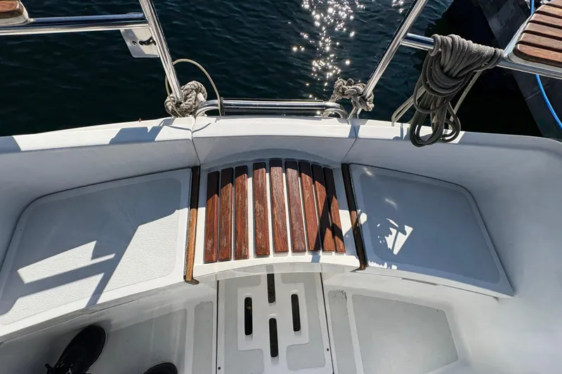 Slide: The Image of Cockpit of a 1993 Hunter 28 sailboat with wooden steps and coiled ropes. - 19