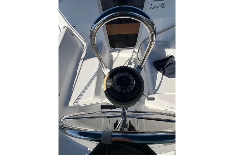 Slide: The Image of Steering wheel and compass on a 1993 Hunter 28 sailboat cockpit. - 21