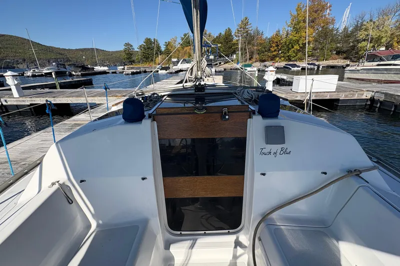 Slide: The Image of Hunter 28 sailboat from 1993 docked at a marina, named "Touch of Blue." - 22