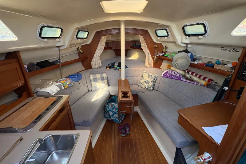 Slide: The Image of Interior of a 1993 Hunter 28 sailboat with cozy seating and wooden accents. - 28