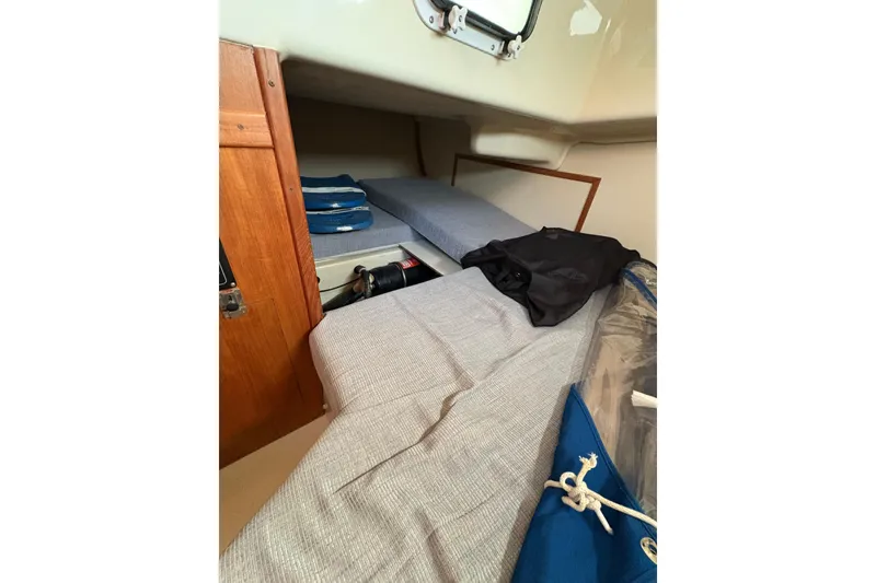 Slide: The Image of Interior cabin of a 1993 Hunter 28 sailboat with storage and bedding. - 30