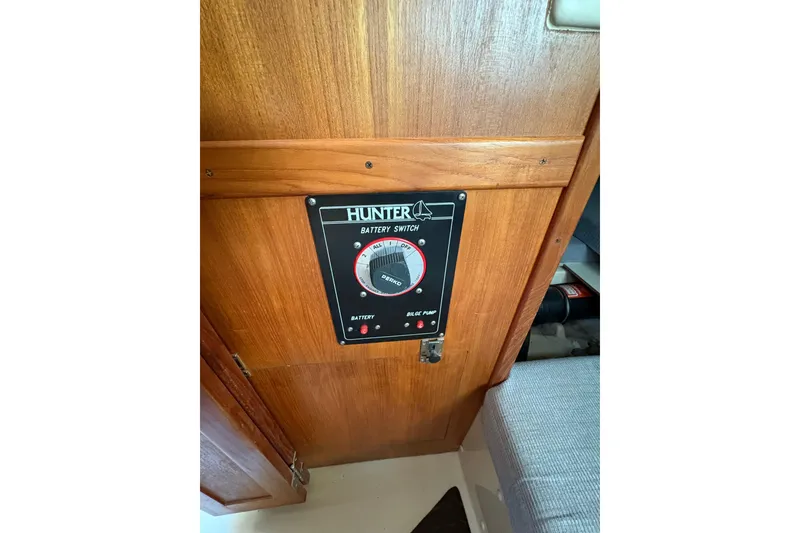 Slide: The Image of Battery switch panel on 1993 Hunter 28 sailboat, mounted on wooden interior. - 32