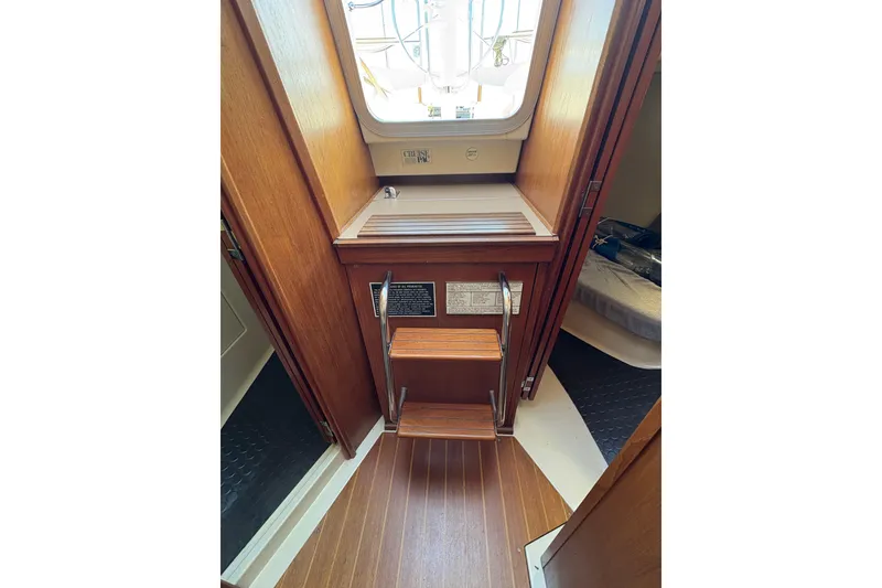 Slide: The Image of Interior of a 1993 Hunter 28 sailboat with wooden steps and cabin view. - 34