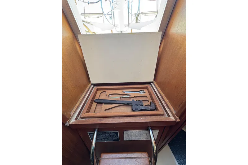 Slide: The Image of Tool compartment on a 1993 Hunter 28 sailboat, featuring various tools. - 35