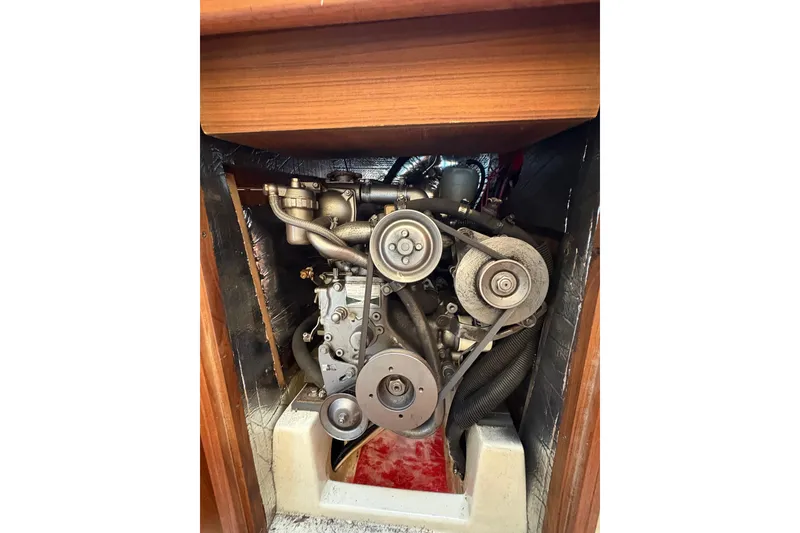 Slide: The Image of Engine compartment of a 1993 Hunter 28 sailboat, showcasing mechanical components. - 36