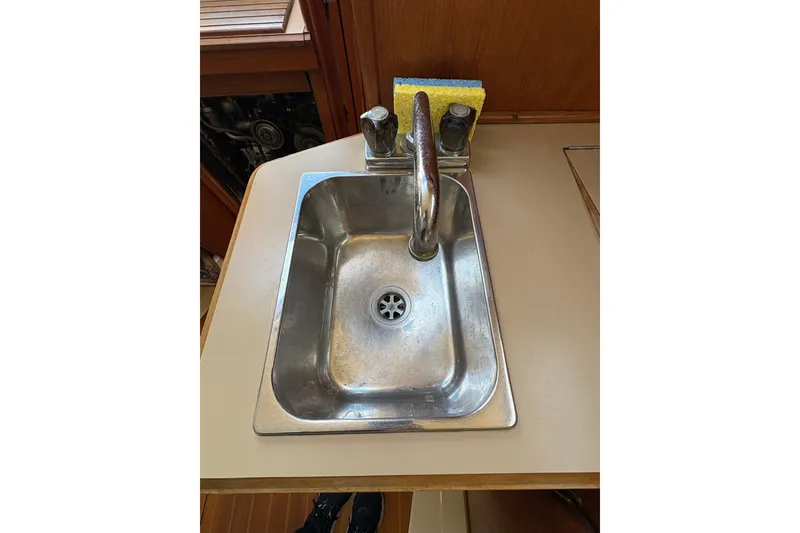 Slide: The Image of Stainless steel sink with faucet in 1993 Hunter 28 boat galley. - 38