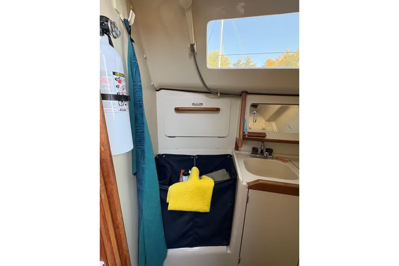 Slide: The Image of Interior of 1993 Hunter 28 sailboat bathroom with sink, mirror, and storage. - 39