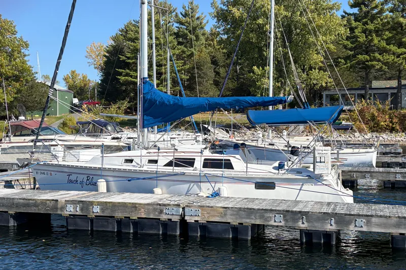 Slide: The Image of Sailboat "Touch of Blue" docked, Hunter 28 model, 1993, with blue sails, marina setting. - 4