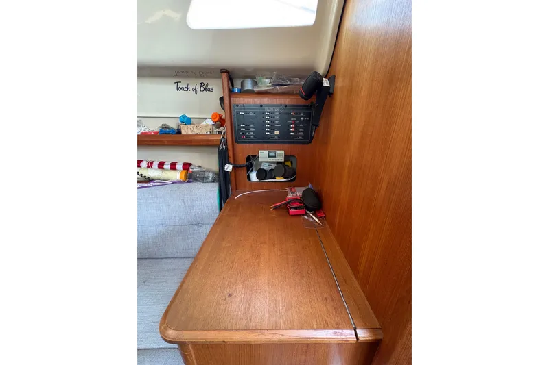 Slide: The Image of Interior of 1993 Hunter 28 sailboat with wooden cabinetry and control panel. - 40