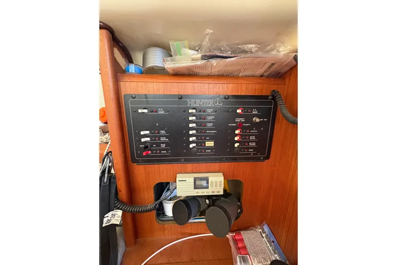 Slide: The Image of Electrical control panel on a 1993 Hunter 28 sailboat, featuring switches and gauges. - 41