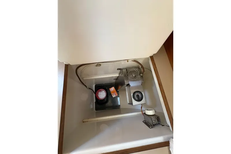 Slide: The Image of Interior view of a 1993 Hunter 28 sailboat compartment with mechanical components. - 43