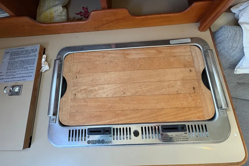 Slide: The Image of Origo 4000 stove with wooden cover in 1993 Hunter 28 sailboat galley. - 45