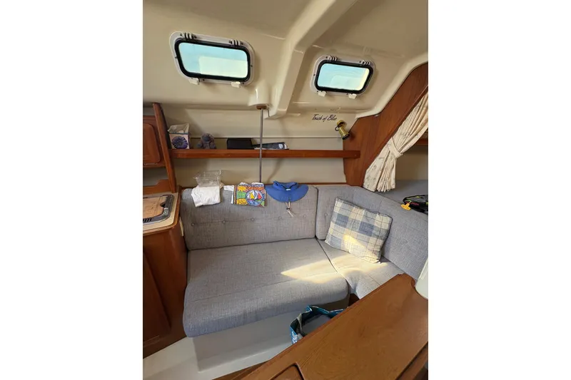 Slide: The Image of Interior of a 1993 Hunter 28 sailboat with cozy seating and nautical decor. - 49