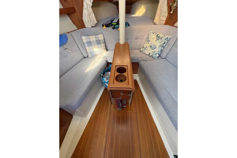 Slide: The Image of Interior of a 1993 Hunter 28 sailboat with cozy seating and wooden flooring. - 51