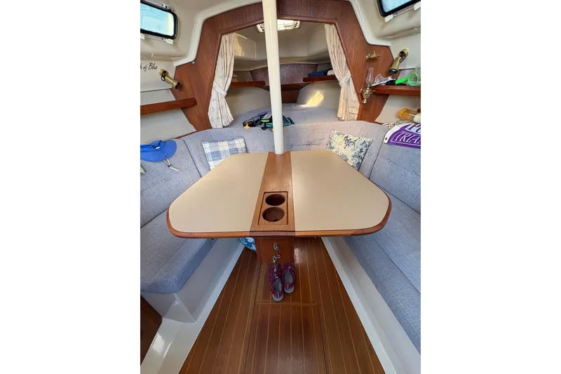 Slide: The Image of Interior of 1993 Hunter 28 sailboat with cozy seating and wooden table. - 52