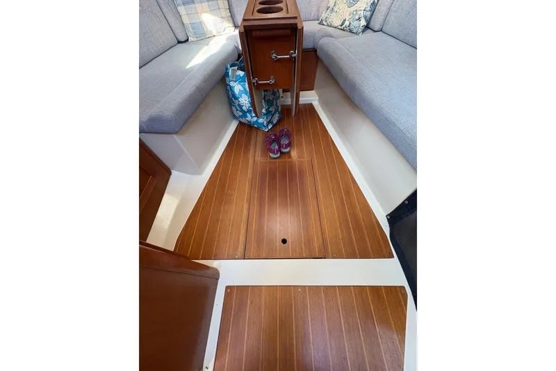 Slide: The Image of Interior of 1993 Hunter 28 sailboat with wooden flooring and cushioned seating. - 55