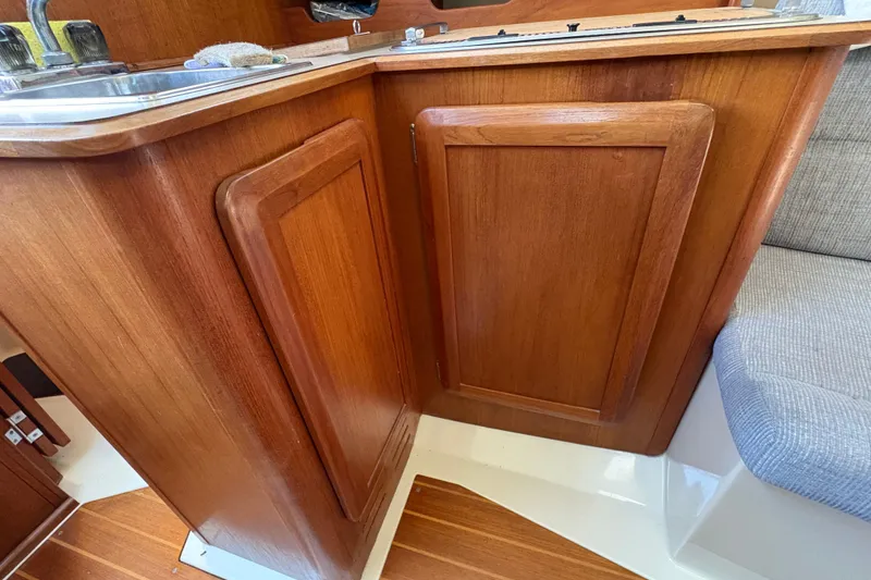 Slide: The Image of Wooden cabinetry in the galley of a 1993 Hunter 28 sailboat interior. - 57