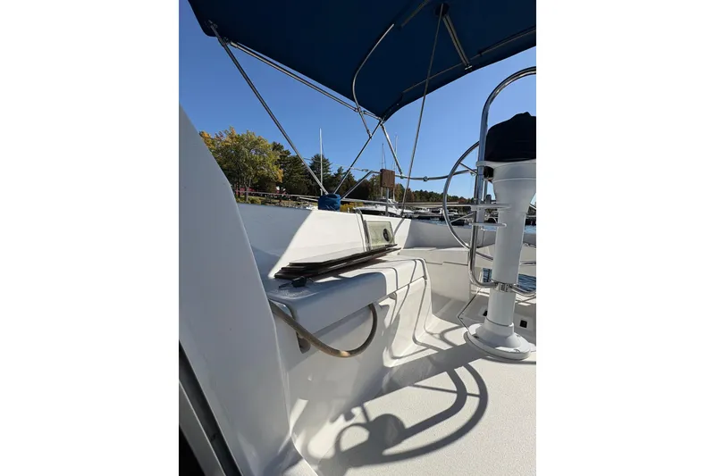 Slide: The Image of Cockpit of a 1993 Hunter 28 sailboat with blue canopy and steering wheel. - 63