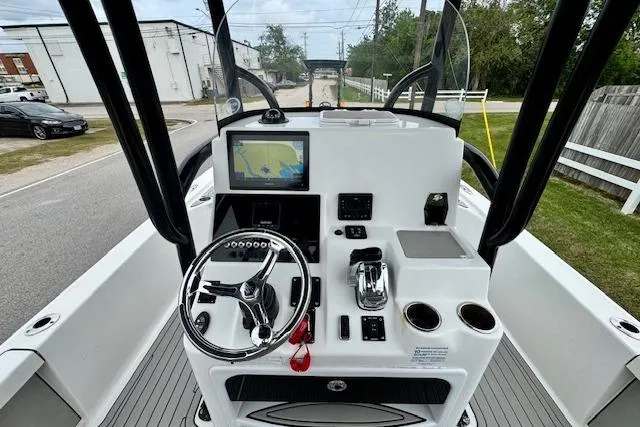 Slide: The Image of 2020 Sea Pro 248 Bay boat dashboard with steering wheel, navigation screen, and controls. - 10
