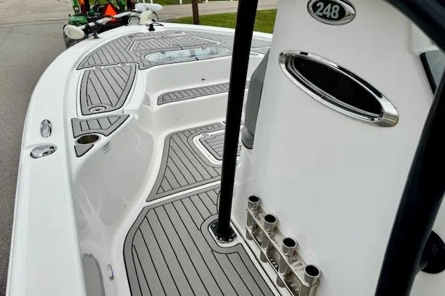 Slide: The Image of 2020 Sea Pro 248 Bay boat deck with sleek design and rod holders. - 12