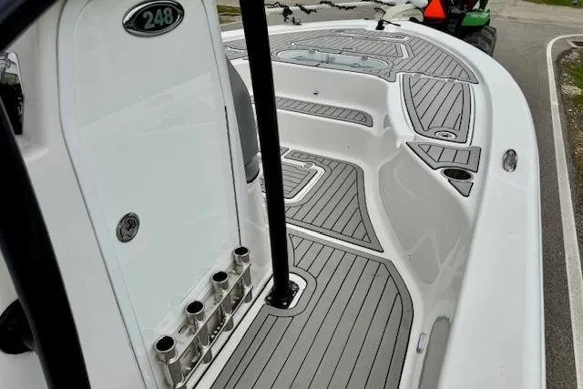 Slide: The Image of 2020 Sea Pro 248 Bay boat deck with sleek design and rod holders. - 14