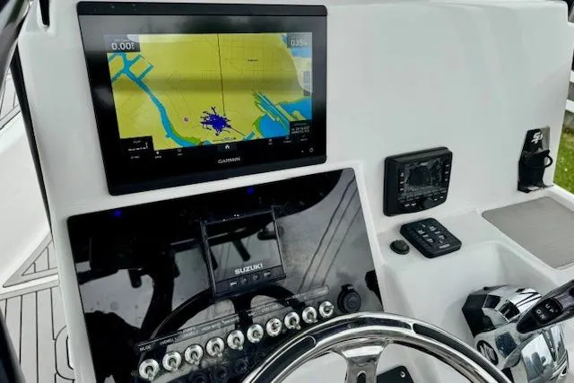 Slide: The Image of 2020 Sea Pro 248 Bay boat dashboard with Garmin navigation display and controls. - 17