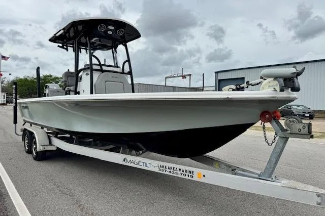 Slide: The Image of 2020 Sea Pro 248 Bay boat on trailer, parked outdoors under cloudy sky. - 5