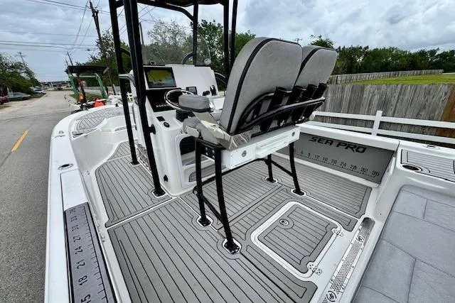 Slide: The Image of 2020 Sea Pro 248 Bay boat interior with seating and console, featuring sleek design and spacious layout. - 8